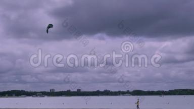 在<strong>暴风雨</strong>的天空中在<strong>海滩</strong>上放风筝的男孩